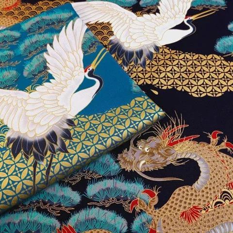 Presentation of 2 black and green Japanese fabrics with birds and dragons motif