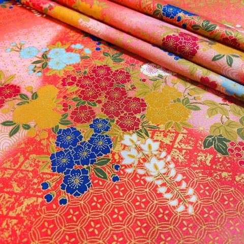 Japanese floral fabric in coral pink with small gold geometric motifs