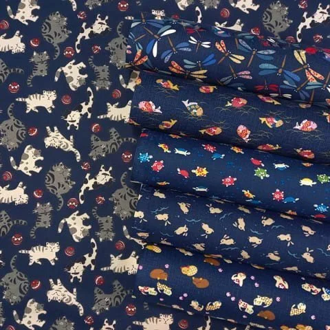 Rolls of navy blue Japanese fabric with animal motifs (Cat, Rabbit, Turtle, Fish, Dragonfly)