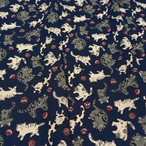 Navy blue Japanese fabric featuring tabby cats playing with a ball