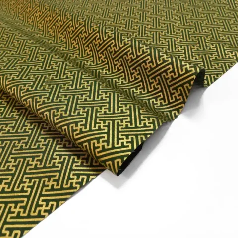 Green fabric with gold geometric print