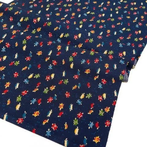 Dark blue Japanese fabric decorated with small multicolored turtles