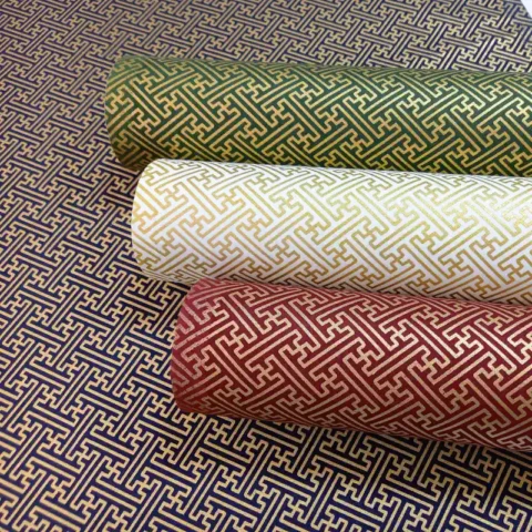 Rolls of Japanese geometric pattern fabric Sayagata in black, green, bordeaux, white